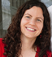 A woman with curly, brown hair and a red shirt